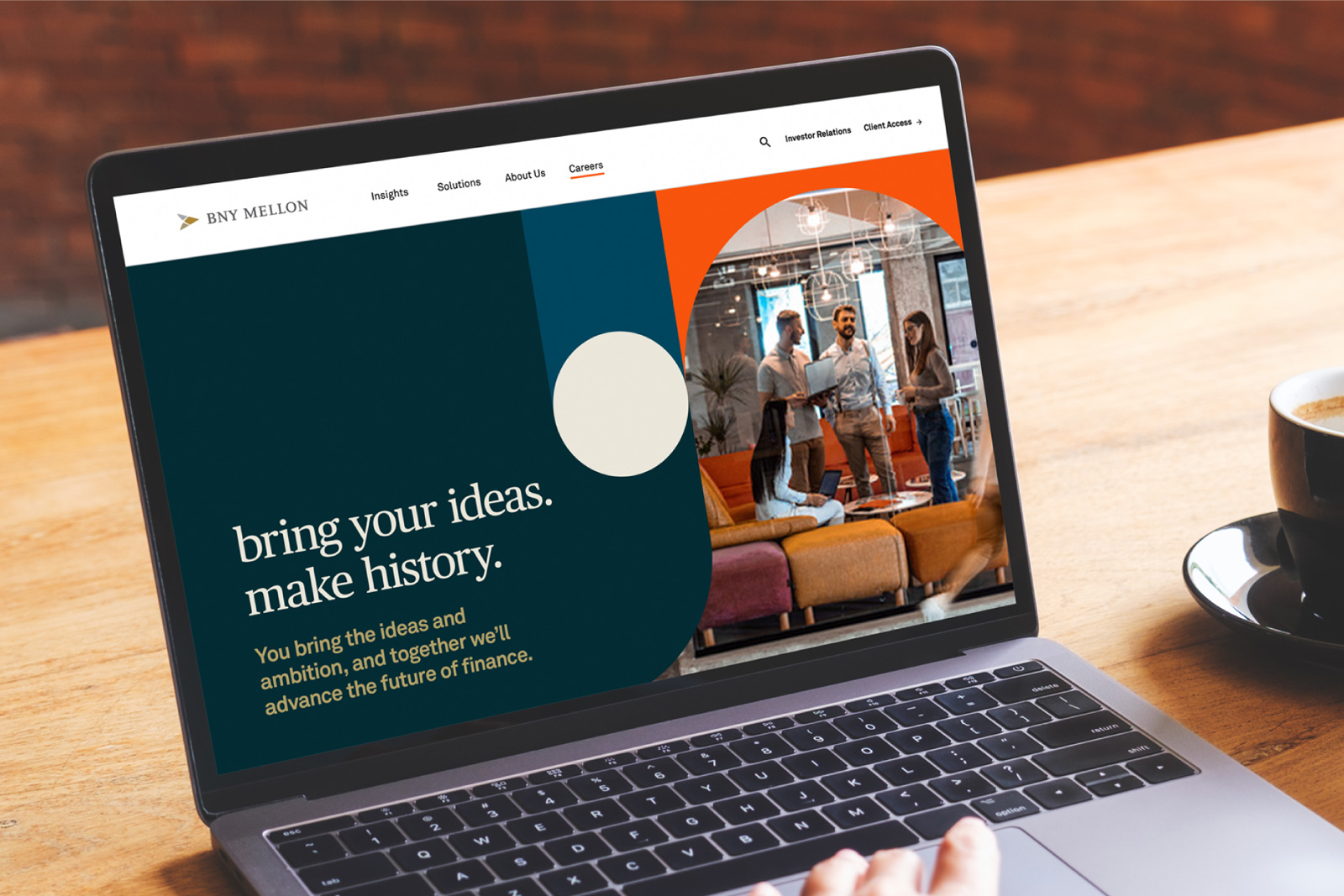 An over-the-shoulder view of a laptop displaying a BNY Mellon employer brand concept applied to a career website layout format by Ingenuity Design.