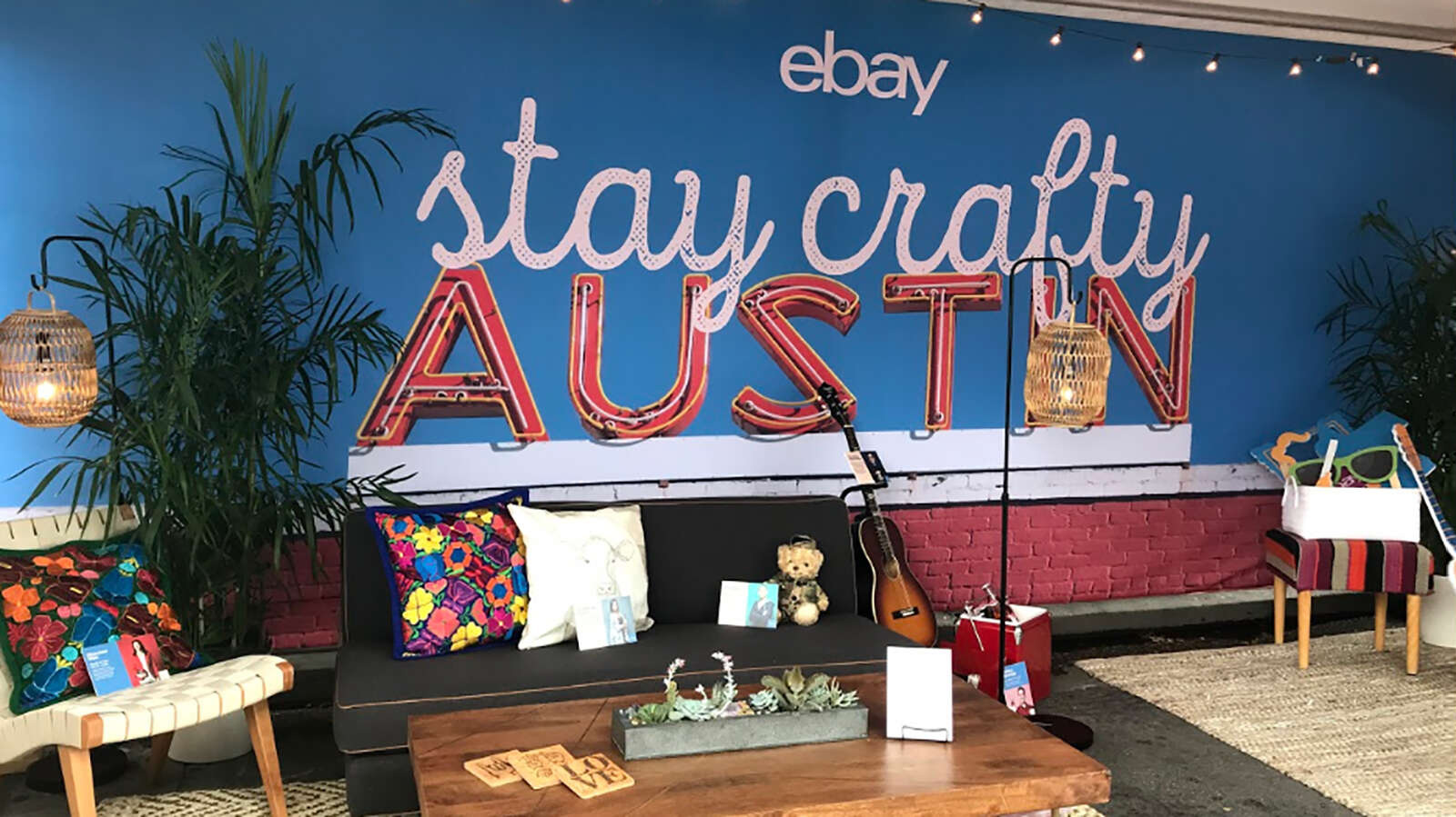 An indoor brand lounge design for an eBay summit featuring custom seating and a neon 'stay crafty' AUSTIN marquee sign.