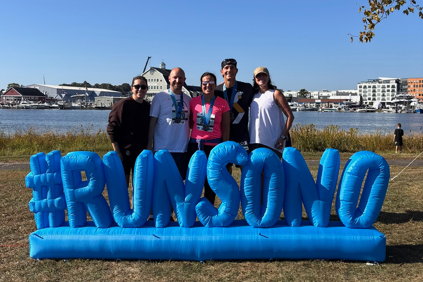 A group photo of the Ingenuity Design agency team smiling together after completing a 5K or half marathon race event in South Norwalk, Connecticut.