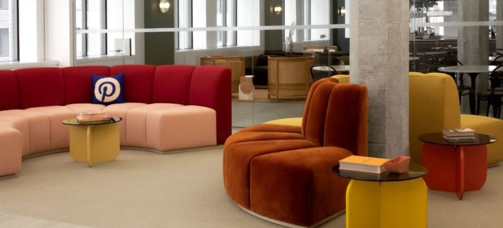 A modern Pinterest office lounge with vibrant seating, reflecting a creative global company culture.