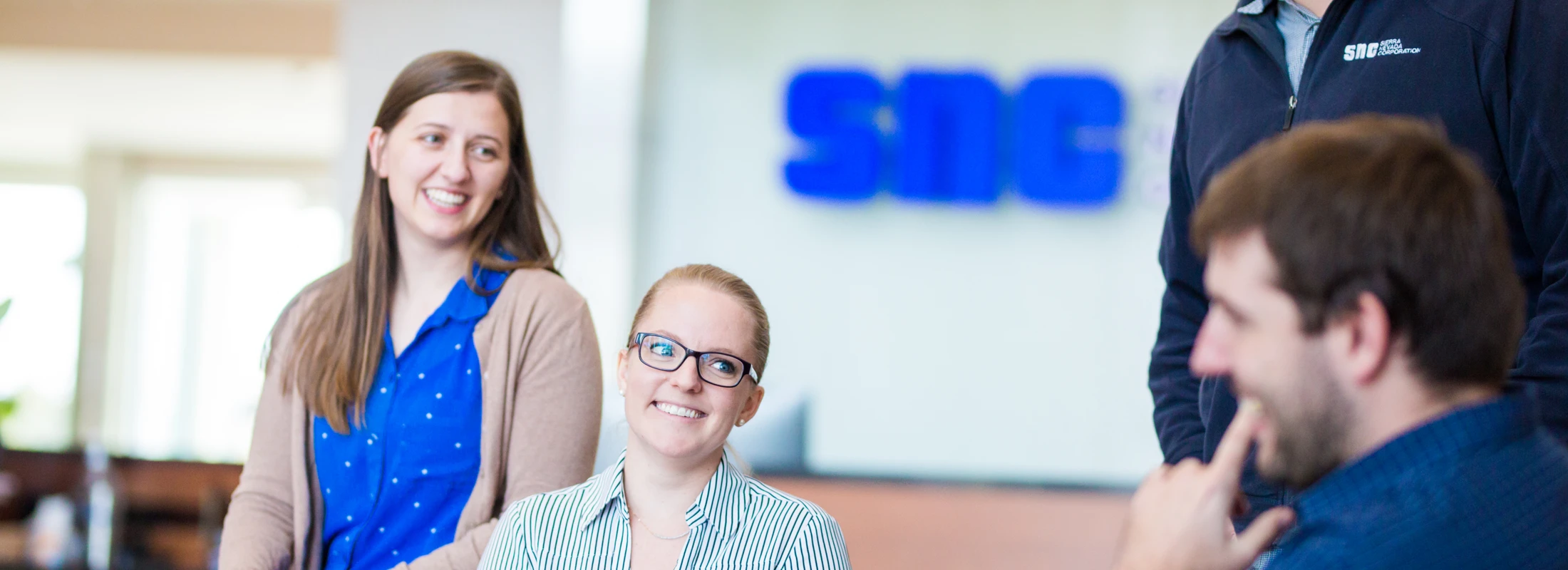 Photo of smiling employees at the Sierra Nevada Corporation